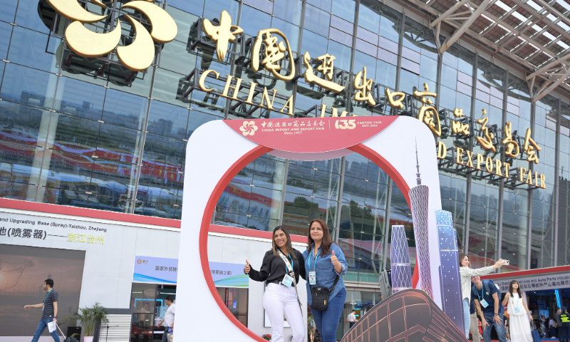 Purchasers take a photo outside the 135th China Import and Export Fair exhibition hall on April 15, 2024. Photo: VCG