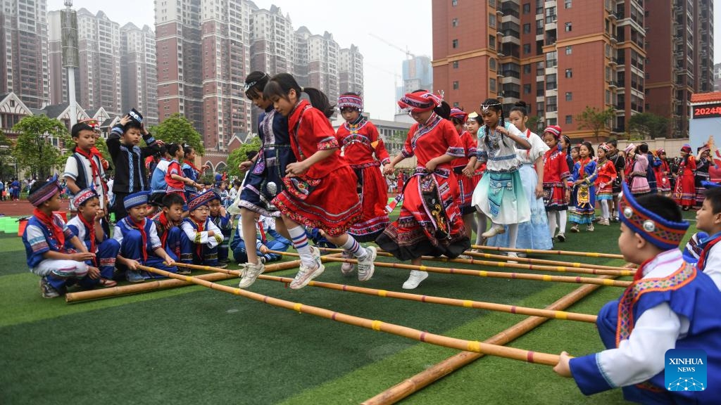 Teachers and pupils of a primary school perform bamboo pole dance in a celebration of Sanyuesan festival in Qinzhou City, south China's Guangxi Zhuang Autonomous Region, April 10, 2024. People of Zhuang ethnic group in Guangxi celebrate the Sanyuesan Festival on the third day of the third lunar month by wearing traditional costumes and having traditional entertainments. This year's Sanyuesan Festival falls on April 11.(Photo: Xinhua)