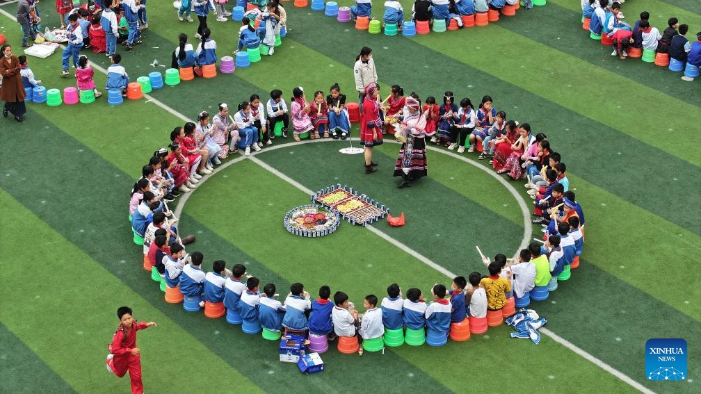 A drone photo taken on April 10, 2024 shows teachers and pupils of a primary school taking part in a celebration of Sanyuesan festival in Qinzhou City, south China's Guangxi Zhuang Autonomous Region. People of Zhuang ethnic group in Guangxi celebrate the Sanyuesan Festival on the third day of the third lunar month by wearing traditional costumes and having traditional entertainments. This year's Sanyuesan Festival falls on April 11.(Photo: Xinhua)