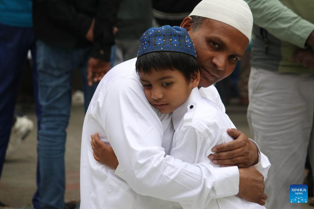 People greet each other while offering Eid al-Fitr prayers at a mosque in Kathmandu, Nepal, April 11, 2024. (Photo: Xinhua)
