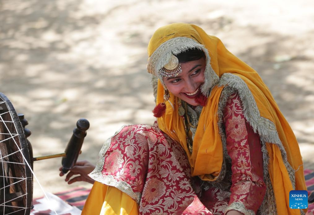 A woman wearing traditional Punjabi attire works on a spinning wheel during a fair celebrating the Baisakhi festival at a college in Amritsar district of India's northern Punjab state, April 9, 2024. Baisakhi is one of the most popular festivals celebrated in the Indian state of Punjab to mark the harvest.(Photo: Xinhua)