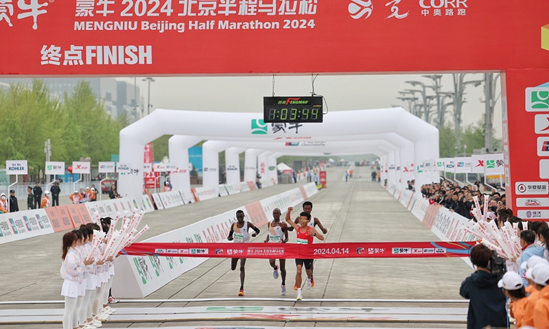 He Jie crosses the finish line of Beijing Half Marathon on April 14, 2024. Photo: VCG
