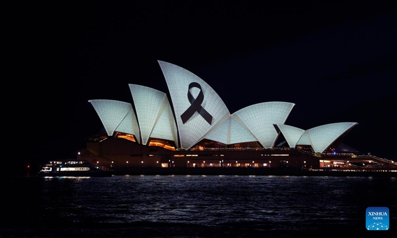 This photo taken on April 15, 2024 shows the Sydney Opera House illuminated with a black ribbon to mourn for victims of the knife attack inside the Westfield Shopping Center at Bondi Junction on April 13, in Sydney, Australia.(Photo: Xinhua)