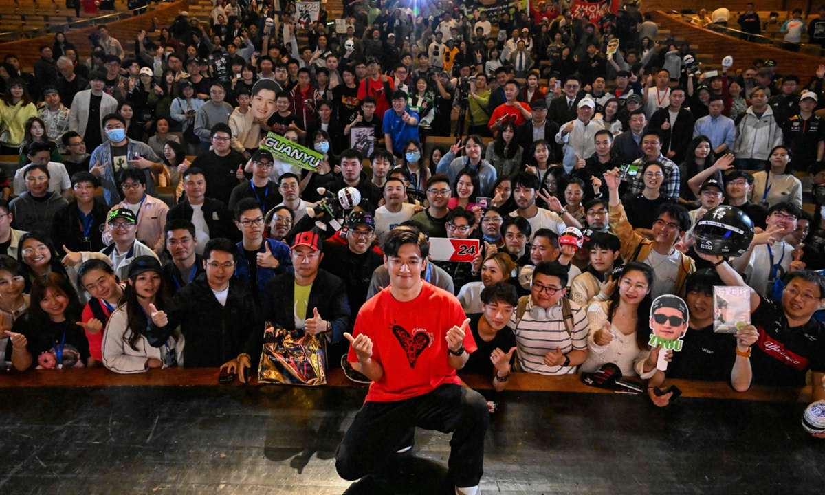 Kick Sauber Ferrari's Chinese driver Zhou Guanyu (front) poses for a picture with his fans after the world premiere of the docu-film <em>The First One</em> in Shanghai on April 16, 2024. The film, which follows Zhou's rise to become the first Chinese Formula One driver, will hit the big screen on Friday to celebrate the 20th anniversary of the Chinese Grand Prix. Photo: VCG