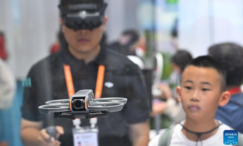 A staff member operates a drone at the booth of Chinese drone maker DJI at the fourth China International Consumer Products Expo (CICPE) in Haikou, capital city of south China's Hainan Province, April 15, 2024. Lasting from April 13 to 18, the expo themed Share Open Opportunities, Co-create a Better Life hosts over 4,000 brands from 71 countries and regions, showcasing their novel and upmarket products for global consumers.(Photo: Xinhua)