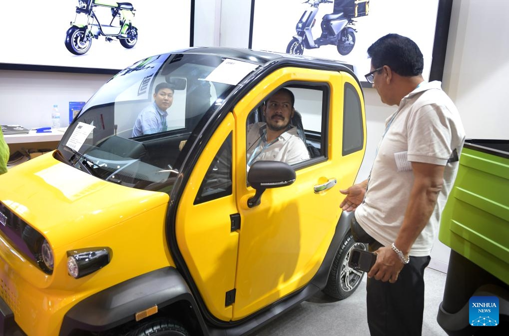 A visitor tries a new energy vehicle during the 135th session of the China Import and Export Fair, also known as the Canton Fair, in Guangzhou, south China's Guangdong Province, April 15, 2024. The 135th session of the Canton Fair opened Monday in Guangzhou. The exhibition area of new energy vehicles attracted numerous visitors from home and abroad.(Photo: Xinhua)