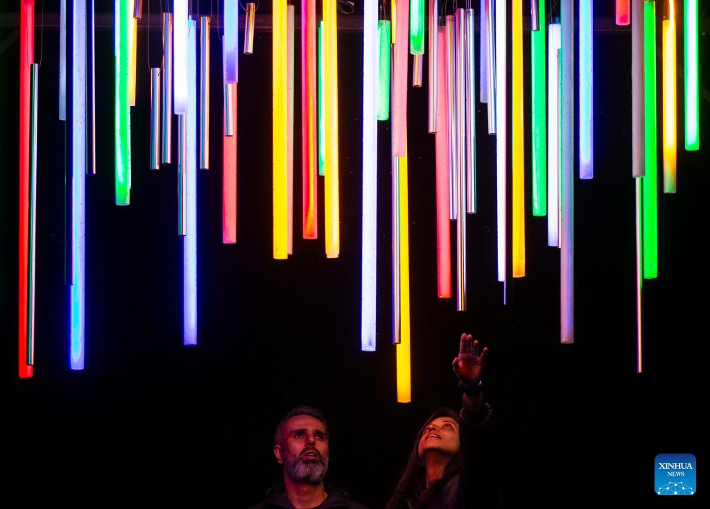 People look at a light art installation during the Lumiere: The Art of Light exhibition in Toronto, Canada, on April 15, 2024. Featuring 17 light installations created by local artists, the outdoor light-based art exhibition is held here from March 12 to April 20.(Photo: Xinhua)