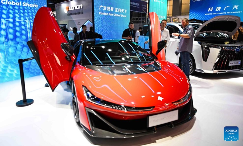 Visitors view a new energy supercar during the 135th session of the China Import and Export Fair, also known as the Canton Fair, in Guangzhou, south China's Guangdong Province, April 15, 2024. The 135th session of the Canton Fair opened Monday in Guangzhou. The exhibition area of new energy vehicles attracted numerous visitors from home and abroad.(Photo: Xinhua)
