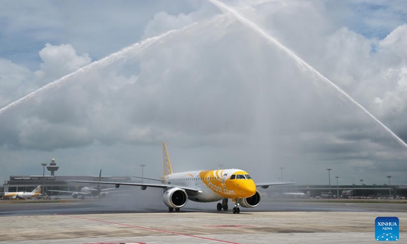 An Embraer E190-E2 passenger aircraft of Singaproe's budget airline Scoot receives water cannon greetings at Singapore's Changi Airport in Singapore on April 15, 2024. Singapore's low-cost airline Scoot held a ceremony at the Changi Airport to receive its first Embraer E 190-E2 jetliner Monday, according to the airline. Named Explorer 3.0, the aircraft departed from Brazil on April 12 and made several fuel stops before receiving water cannon greetings in Singapore.(Photo: Xinhua)