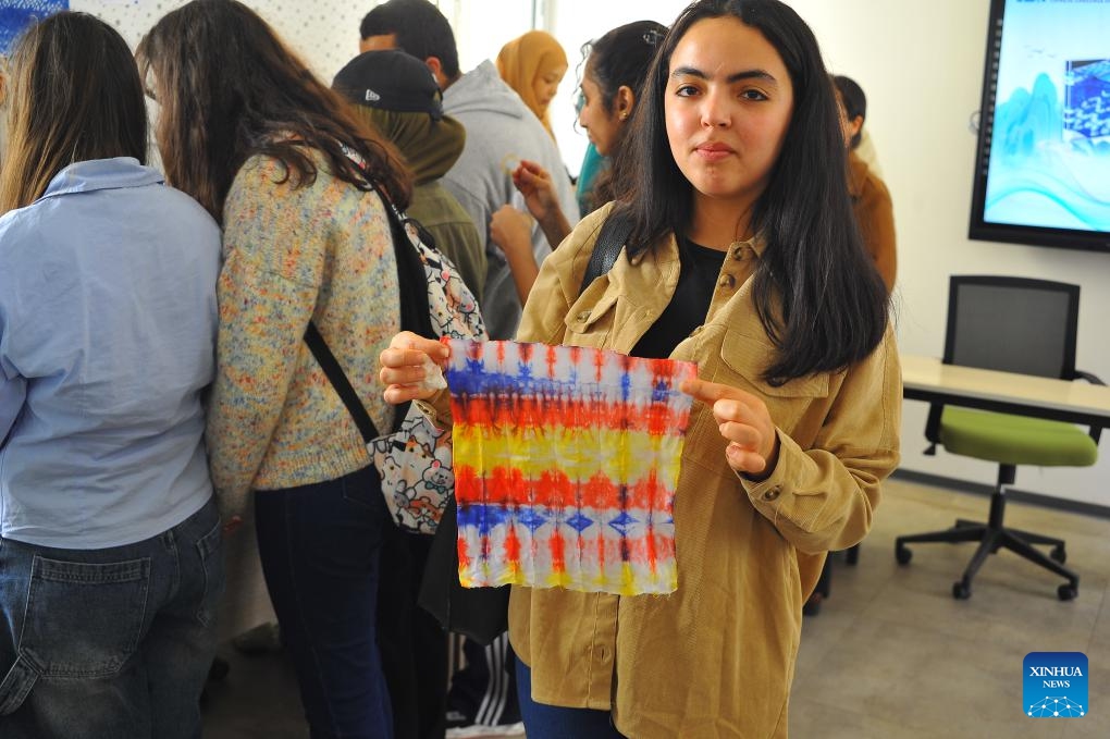 A student shows her tie-dye work in the Confucius Institute at Carthage University in Tunis, Tunisia, on April 17, 2024. Tunisia on Wednesday celebrated this year's United Nations Chinese Language Day, which falls on April 20, by holding a cultural event here in the capital city.(Photo: Xinhua)