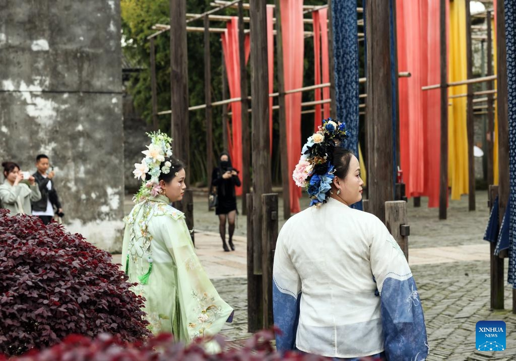 Tourists donning traditional attire visit a dyeing house in the water town Wuzhen in Jiaxing City, east China's Zhejiang Province, April 11, 2024. Located in east China's Zhejiang Province, the waterside city Jiaxing is renowned for tourist destinations Nanhu Lake and Wuzhen. In the breezy month of April, the two tourist hotspots come alive with the gentle touch of spring. Nanhu Lake, with its shimmering waters and willow trees swaying along the lakeside, is a sight to behold.(Photo: Xinhua)