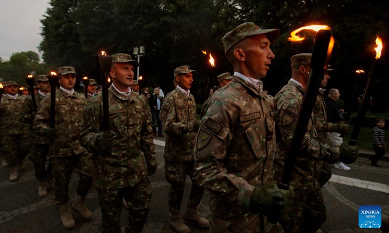 Soldiers carrying torches march to celebrate the upcoming Romanian Land Forces Day, in Bucharest, Romania, April 21, 2024. (Photo by Cristian Cristel/Xinhua)