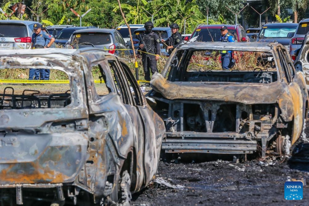 Multiple charred vehicles are seen after a fire at the parking area of Ninoy Aquino International Airport Terminal 3 in Pasay City, the Philippines, on April 22, 2024. At least 19 vehicles were burned in the incident. No one was reported hurt and all flights remained undisrupted, as airport authorities are investigating what caused the fire.(Photo; Xinhua)