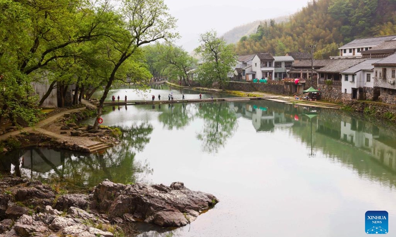 Tourists visit Zhongcun Village of Luting Township, Yuyao City, east China's Zhejiang Province, April 13, 2024. Sticking to the concept of lucid waters and lush mountains are invaluable assets, Luting Township has taken local environment as an advantage to develop ecological industry and to promote the countryside tourism.(Photo: Xinhua)