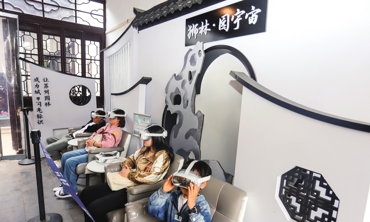 Tourists experience a virtual reality (VR) tour of  the Lion Forest Garden in Suzhou, East China's Jiangsu Province on April 23, 2024. Relying on VR and other digital technologies, the project combines a traditional garden with high-tech products, allowing visitors to try a new way of touring the digital garden. Photo: VCG