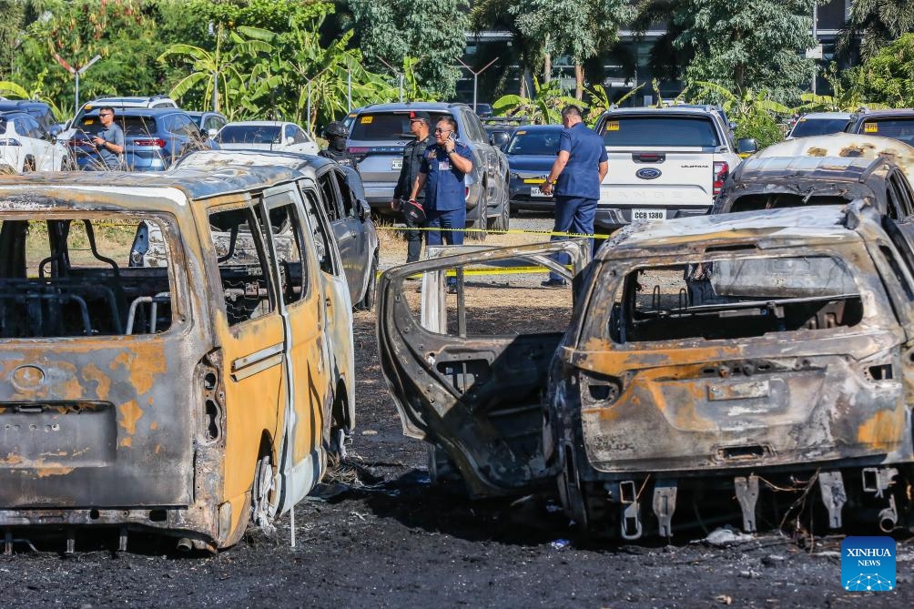 Multiple charred vehicles are seen after a fire at the parking area of Ninoy Aquino International Airport Terminal 3 in Pasay City, the Philippines, on April 22, 2024. At least 19 vehicles were burned in the incident. No one was reported hurt and all flights remained undisrupted, as airport authorities are investigating what caused the fire.(Photo; Xinhua)