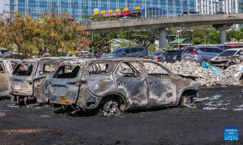 Multiple charred vehicles are seen after a fire at the parking area of Ninoy Aquino International Airport Terminal 3 in Pasay City, the Philippines, on April 22, 2024. At least 19 vehicles were burned in the incident. No one was reported hurt and all flights remained undisrupted, as airport authorities are investigating what caused the fire.(Photo; Xinhua)
