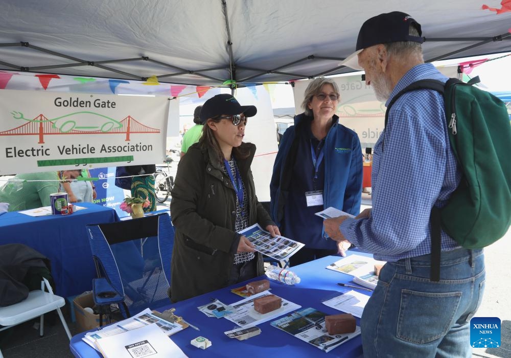 A staff member (L) explains to a visitor (R) during the San Francisco Earth Day Festival in San Francisco, the United States, April 21, 2024.(Photo: Xinhua)