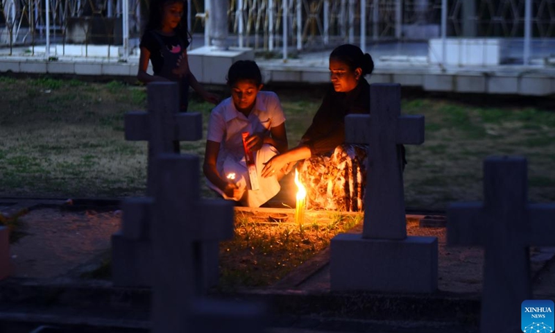 People pay tribute to a victim of the Easter Sunday terror attacks at a cemetery in Katuwapitiya, Sri Lanka, April 21, 2024. People on Sunday commemorated victims killed in the suicide blasts in 2019, marking the 5th anniversary of the Easter Sunday terror attacks.(Photo; Xinhua)