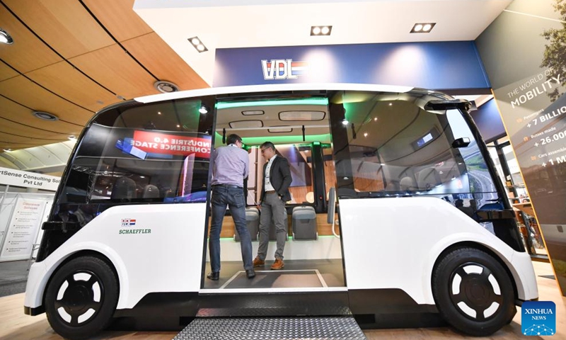 People look at a self-driving shuttle bus at Hannover Messe in Hannover, Germany, on April 23, 2024. Hannover Messe 2024, Germany's leading industrial trade fair, kicked off on Monday with a clear emphasis on carbon-neutral production and hydrogen fuel cells.(Photo: Xinhua)