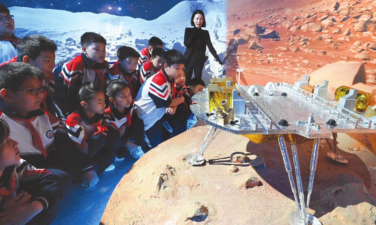 Students from Zhaowang Primary School in Handan, North China's Hebei Province, look at a model of China's Mars probe Tianwen-1 at the Science and Technology Museum on April 24, 2024. 
Photo: IC