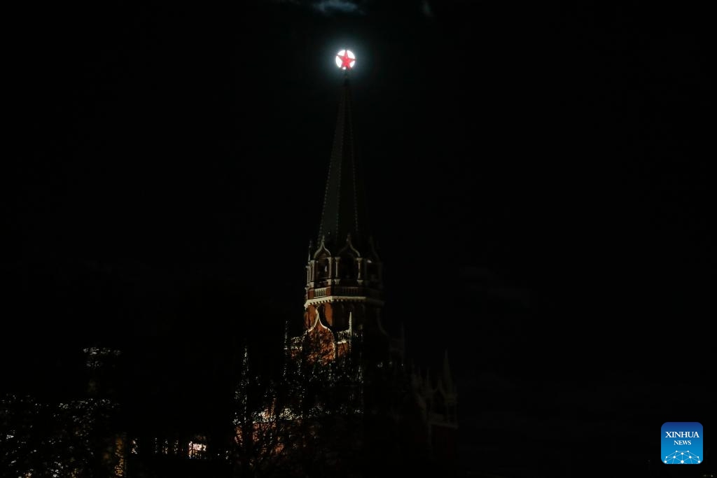 A full moon rises behind a red star on the top of a Kremlin tower in Red Square in Moscow, Russia, on April 23, 2024.(Photo: Xinhua)