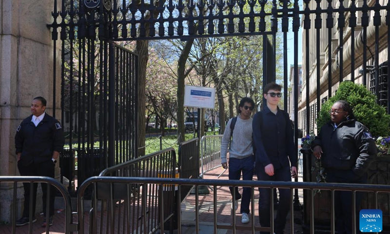 Security guards stand at a gate of Columbia University's Morningside Heights campus in New York City, the United States, April 22, 2024. All classes at Columbia University went virtual starting on Monday as divisive demonstrations and debates around the Israel-Hamas conflict heated up on campus recently.(Photo: Xinhua)