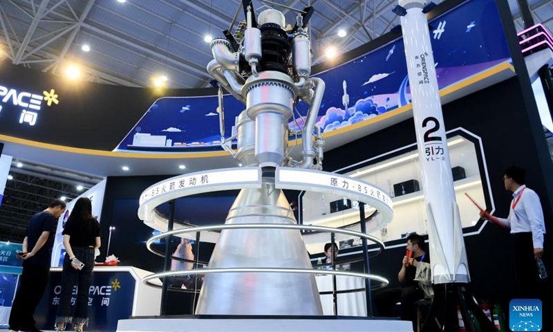People look at a model of rocket engine at an exhibition on aerospace in Wuhan, central China's Hubei Province, April 23, 2024. The exhibition, as a part of the celebration of the Space Day of China this year, features science popularization and achievements of aerospace industry, exposing visitors to a comprehensive view of China's aerospace industry and its accomplishments in recent years.(Photo: Xinhua)