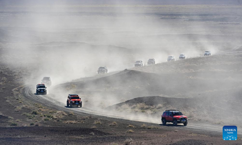Tourists drive off-road vehicles in Urho District of Karamay, northwest China's Xinjiang Uygur Autonomous Region, May 2, 2024. During the May Day holiday, Urho District of Karamay City has become a popular travel destination for tourists from all over the country. Various activities such as low-altitude flight, no-man's land crossing, RV camping, and off-road motorcycling have been carried out here to meet the diverse and personalized needs of tourists. In recent years, Xinjiang has taken full advantages of its rich natural resources to develop outdoor tourism projects and thus new growth opportunities have emerged in Xinjiang's thriving tourism industry. (Xinhua/Ding Lei)