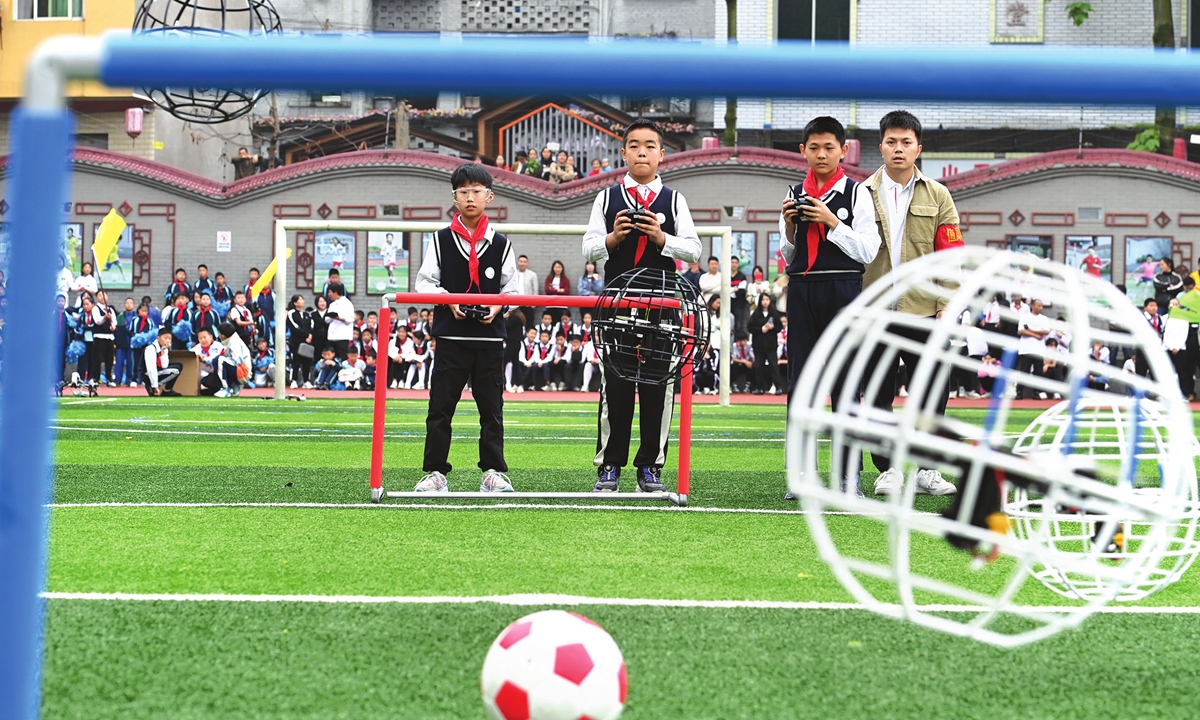 Students take part in a soccer match with drones at the Shandong Primary School in the Shapingba district of Southwest China's Chongqing Municipality on April 25, 2024. The school is an outstanding characteristic school for national youth soccer. Photo: VCG