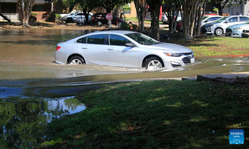 A car is seen in floodwaters in a residential area in Spring, Texas, the United States, May 2, 2024. Multiple rounds of thunderstorms are worsening flooding threats on Thursday across eastern Texas, including the Houston area, forcing evacuations and school closures. (Photo by Chengyue Lao/Xinhua)