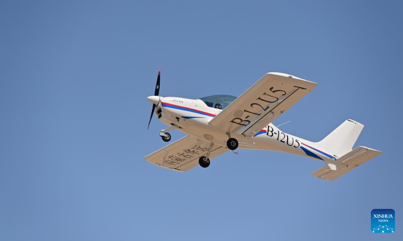 A low-altitude flight with tourists aboard flys over a scenic area in Urho District of Karamay, northwest China's Xinjiang Uygur Autonomous Region, May 1, 2024. During the May Day holiday, Urho District of Karamay City has become a popular travel destination for tourists from all over the country. Various activities such as low-altitude flight, no-man's land crossing, RV camping, and off-road motorcycling have been carried out here to meet the diverse and personalized needs of tourists. In recent years, Xinjiang has taken full advantages of its rich natural resources to develop outdoor tourism projects and thus new growth opportunities have emerged in Xinjiang's thriving tourism industry. (Xinhua/Ding Lei)