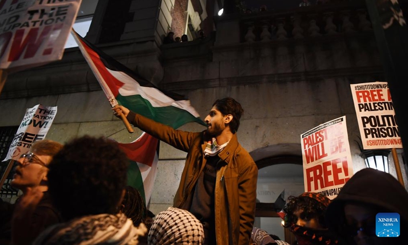 A man waves a Palestinian flag during a pro-Palestinian demonstration outside Columbia University in New York, the United States, on April 23, 2024. Columbia University, amidst an eighth day of tense demonstrations, said on Wednesday that it has extended negotiations with student activists regarding the dismantling of a pro-Palestinian encampment.(Photo: Xinhua)