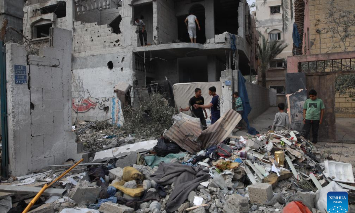 People gather near the rubble of a destroyed house in central Gaza Strip city of Deir el-Balah, on May 1, 2024. Photo:Xinhua