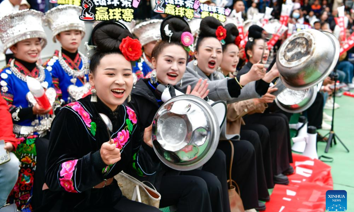 Cheerleaders cheer for players on the closing day of the 1st Guizhou's 