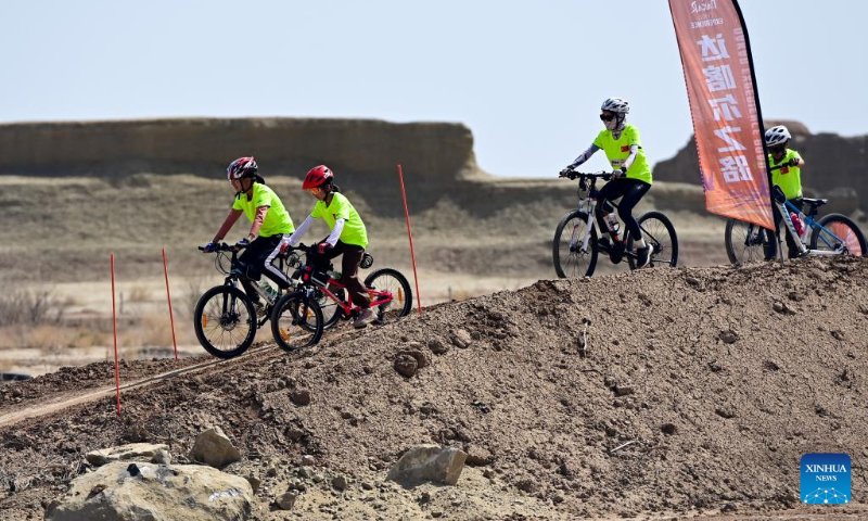 Children ride off-road bikes on a road trip route at a scenic area in Urho District of Karamay, northwest China's Xinjiang Uygur Autonomous Region, May 1, 2024. During the May Day holiday, Urho District of Karamay City has become a popular travel destination for tourists from all over the country. Various activities such as low-altitude flight, no-man's land crossing, RV camping, and off-road motorcycling have been carried out here to meet the diverse and personalized needs of tourists. In recent years, Xinjiang has taken full advantages of its rich natural resources to develop outdoor tourism projects and thus new growth opportunities have emerged in Xinjiang's thriving tourism industry. (Xinhua/Ding Lei)