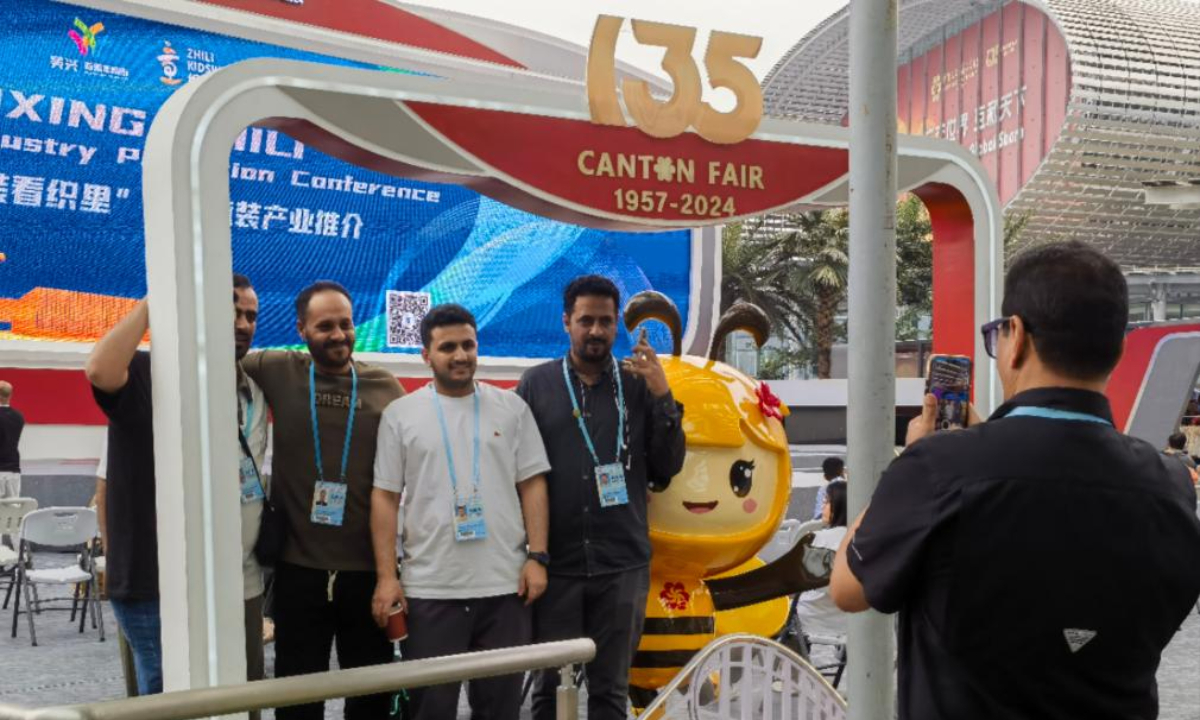 Foreign merchants pose for a photo with a mascot outside the venue of the third phase of the Canton Fair in Guangzhou, south China's Guangdong Province, May 1, 2024. The five-day third phase of the fair started on Wednesday, with the participation of 11,000 enterprises. Photo:Xinhua
