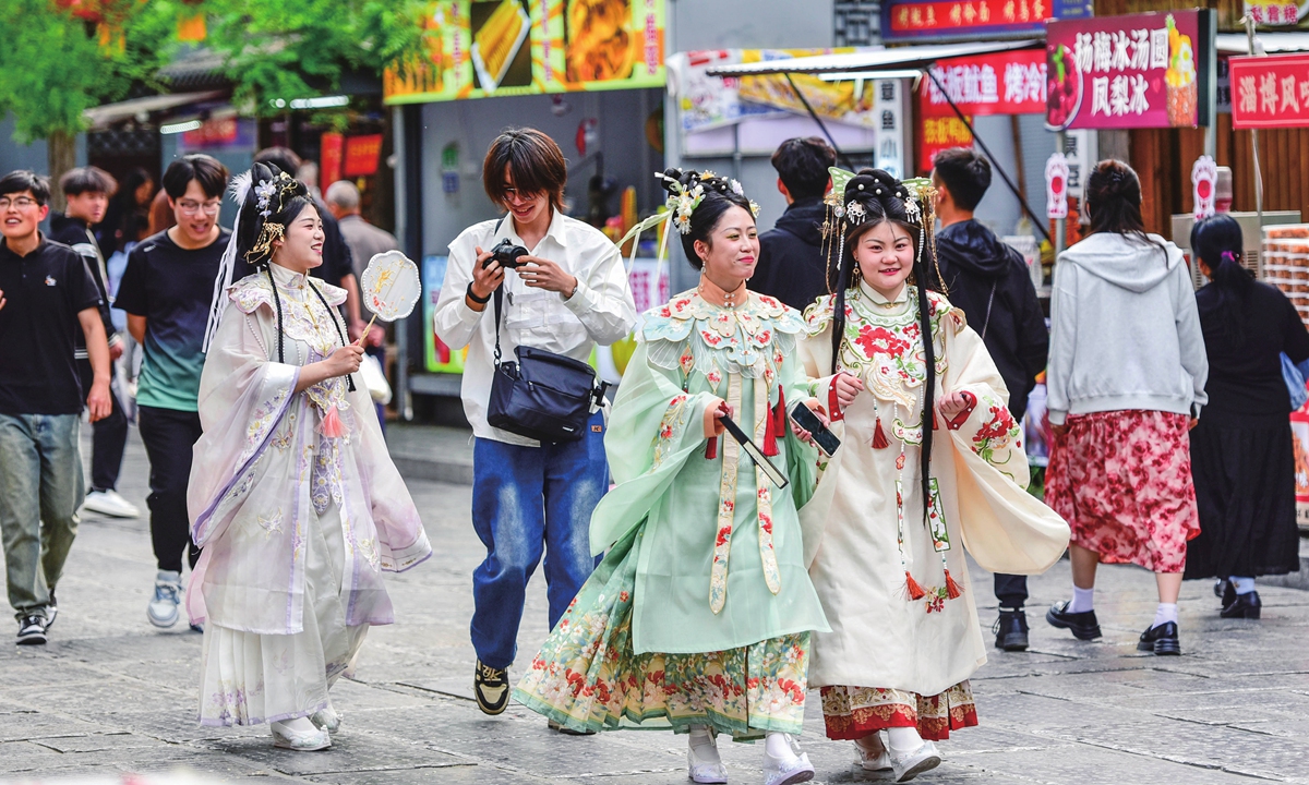 Tourists in traditional clothes visit Qingzhou ancient town scenic spot in Weifang. Photo: VCG