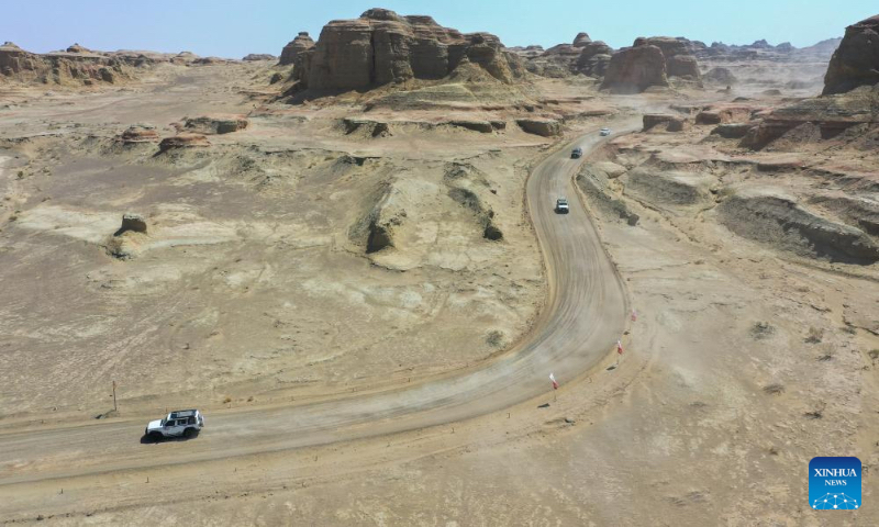 This aerial drone photo taken on May 1, 2024 shows tourists driving car on a road trip route at a scenic area in Urho District of Karamay, northwest China's Xinjiang Uygur Autonomous Region. During the May Day holiday, Urho District of Karamay City has become a popular travel destination for tourists from all over the country. Various activities such as low-altitude flight, no-man's land crossing, RV camping, and off-road motorcycling have been carried out here to meet the diverse and personalized needs of tourists. In recent years, Xinjiang has taken full advantages of its rich natural resources to develop outdoor tourism projects and thus new growth opportunities have emerged in Xinjiang's thriving tourism industry. (Xinhua/Ding Lei)