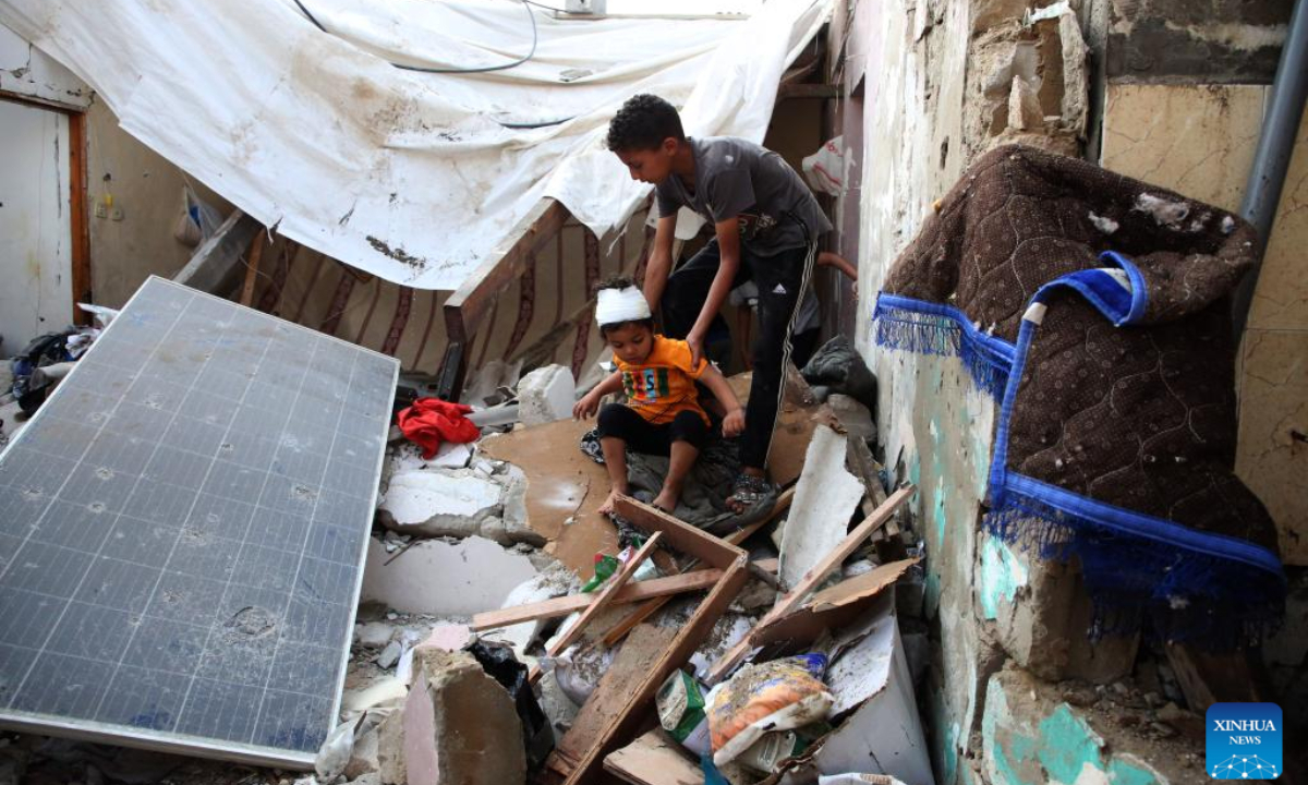 Children are seen among the rubble of a destroyed house in the southern Gaza Strip city of Rafah, on May 1, 2024. Photo:Xinhua