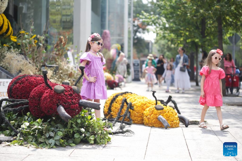 Children pose for photos with flower-decorated installations during the Flowers and Gardens Festival in Mexico City, Mexico, April 26, 2024.(Photo: Xinhua)
