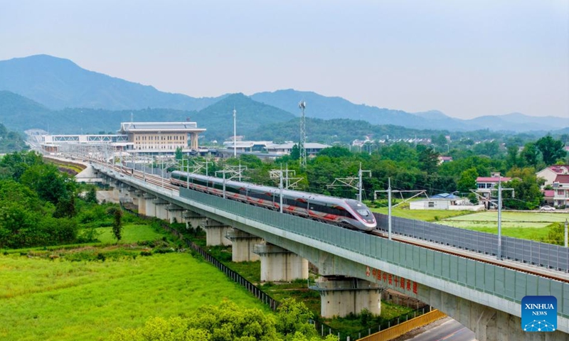 A drone photo shows a train running on the Qingtonghe grand bridge along the Chizhou-Huangshan Railway in east China's Anhui Province, April 26, 2024. Chizhou-Huangshan Railway, linking Chizhou City and Huangshan City of east China's Anhui Province, started operation on Friday. It is a tourism route connecting Jiuhua Mountain, Huangshan Mountain, Taiping Lake and other tourist attractions, which is of great significance for promoting the economic and social development along the route.(Photo: Xinhua)