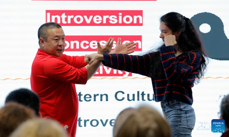 A Chinese Tai Chi master (L) demonstrates as a member of the audience assists during a lecture themed feel the beauty of Tai Chi and share the joy of health at the Chinese Cultural Center in Bucharest, Romania, April 26, 2024. The World Tai Chi Day is celebrated on the last Saturday of April every year. Photo: Xinhua