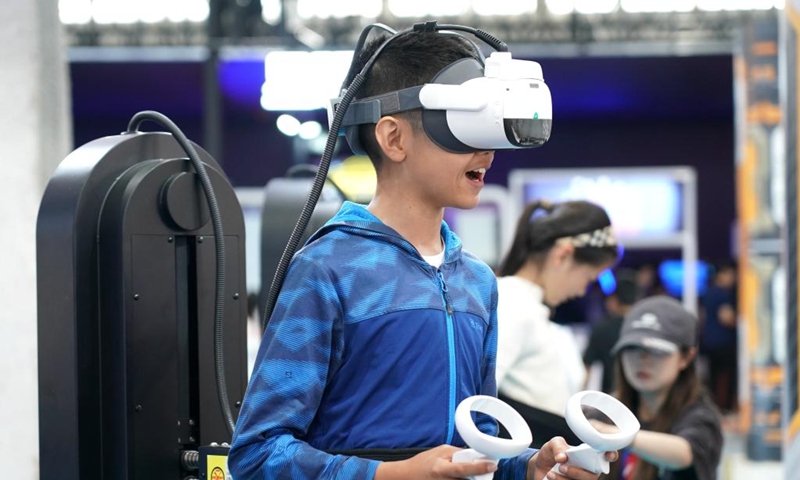 A boy plays a VR game at a science fiction carnival alongside the China Science Fiction Convention (CSFC) 2024 in Beijing, capital of China, April 27, 2024. Photo: Xinhua