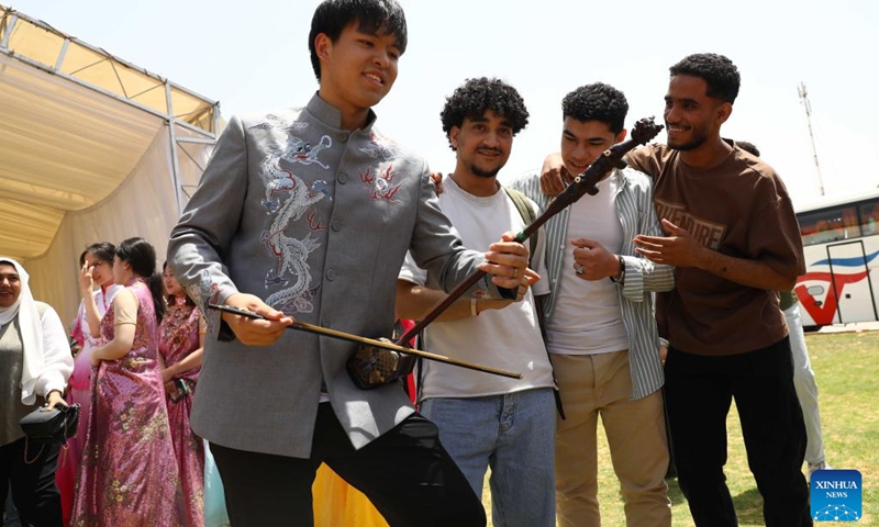 Egyptian students enjoy a traditional Chinese musical instrument performance during a ceremony to celebrate Chinese Language Day in Cairo, Egypt, April 27, 2024. Students studying in Egyptian colleges celebrated Saturday the United Nations Chinese Language Day with a themed event featuring a concert, food and tea tasting, sketch comedy, and art show. Photo: Xinhua