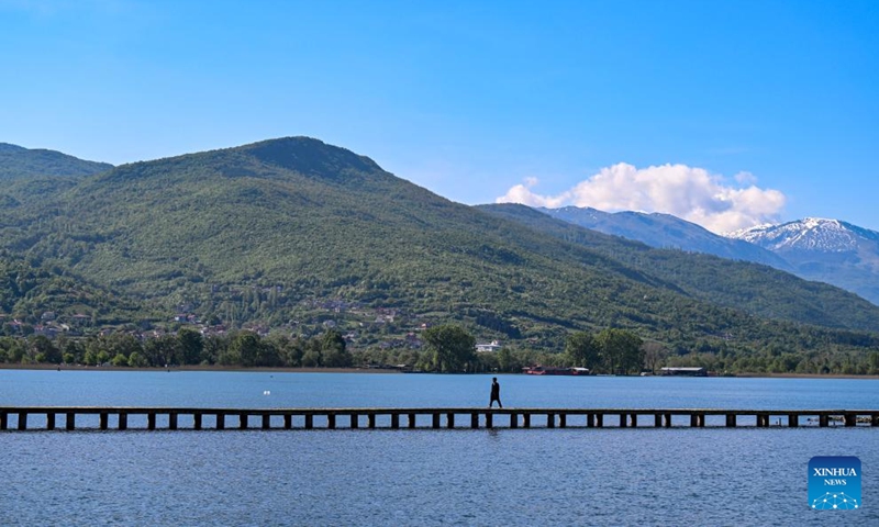 A man walks on a bridge at Ohrid Lake in Ohrid, North Macedonia, April 27, 2024. Photo: Xinhua