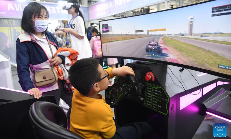 A boy plays a car racing game at a science fiction carnival alongside the China Science Fiction Convention (CSFC) 2024 in Beijing, capital of China, April 27, 2024. Photo: Xinhua