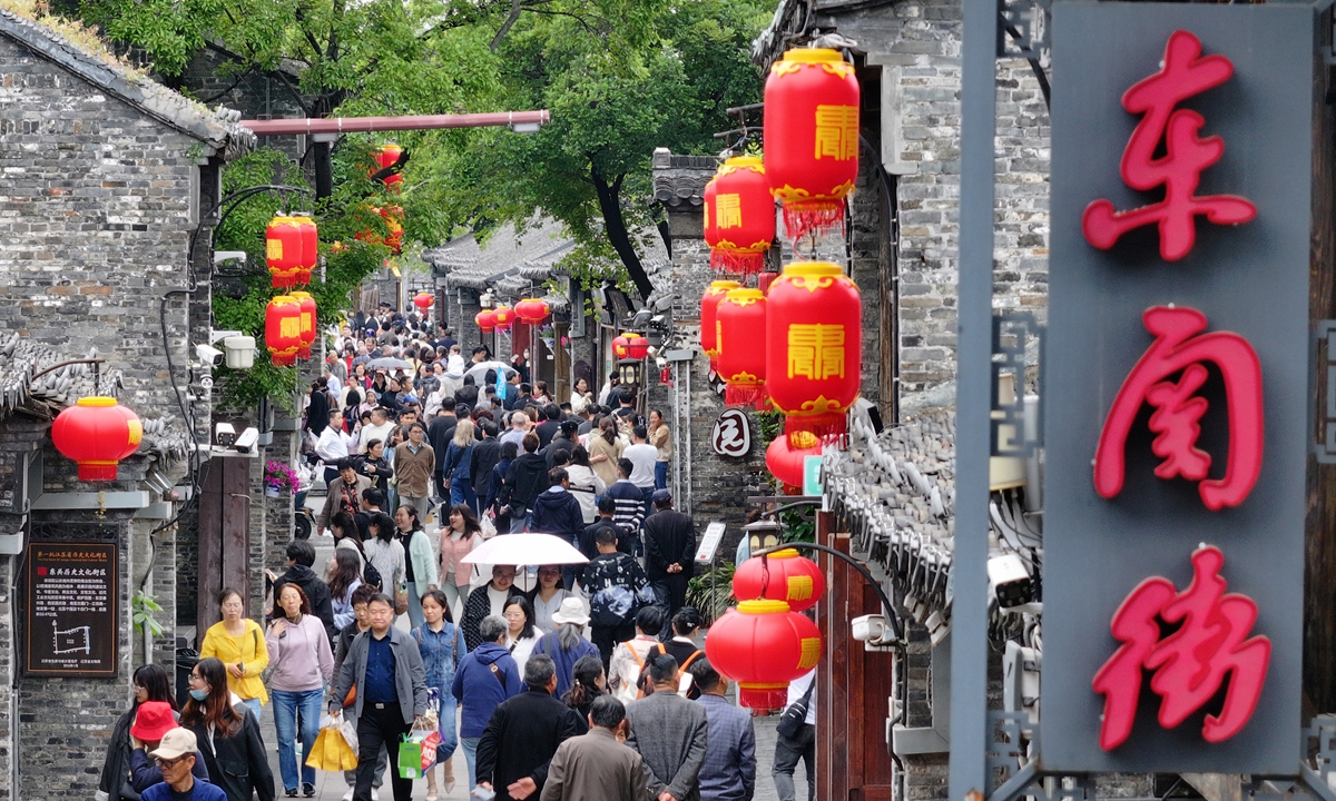 
People shop and sightsee along Dongguan Street in Yangzhou, East China's Jiangsu Province on April 28, 2024. Yangzhou, like many other Chinese cities, is expected to see another travel boom during the upcoming five-day May Day holidays, lasting from May 1 to 5 this year. Photo: VCG
