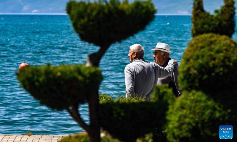 People walk on the shore of Ohrid lake in Ohrid, North Macedonia, April 27, 2024. Photo: Xinhua