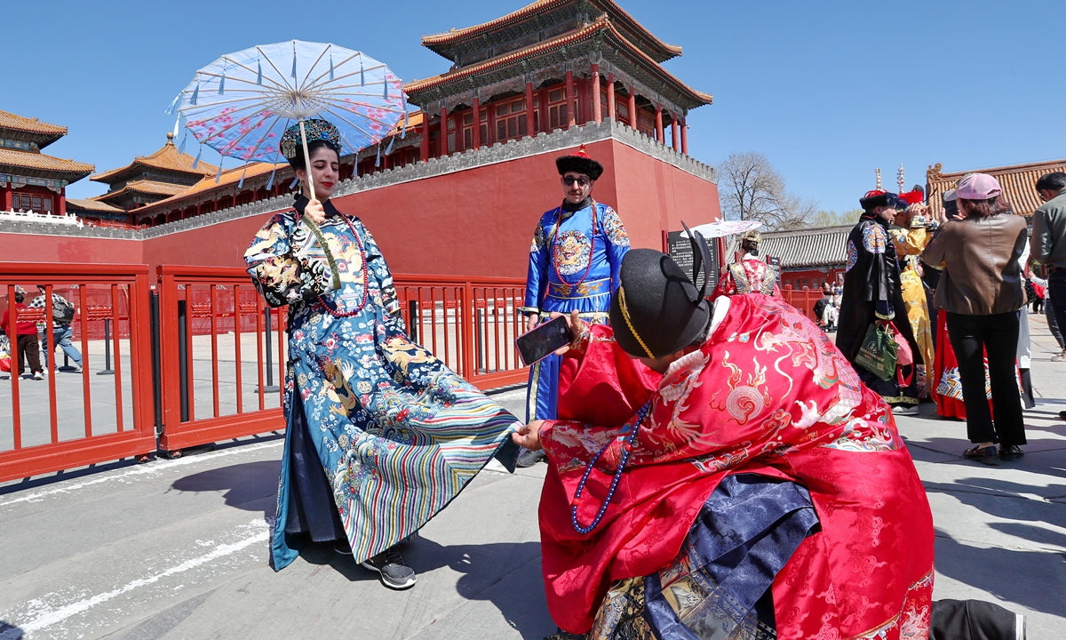 Foreign tourists wearing traditional costumes visit the Forbidden City to experience traditional Chinese culture in Beijing on March 22, 2024. Photo: VCG